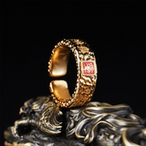 Tian Guan Ci Fu Ring – gold open ring with red seal and dragon carving on black stand, blessing protection amulet ring