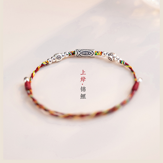 Koi Red String Bracelet – multicolor braided cord with silver koi charm on white background, luck protection anklet