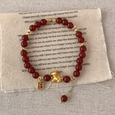 Horse Year Bracelet – red glass beads with gold horse charm on beige fabric, wealth luck jewelry