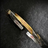 Tai Chi Bagua Bracelet – two-tone silver gold cuff with engraved symbols on black stone, protection wealth