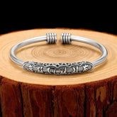 Om Mani Padme Hum Cuff Bracelet – Silver cuff with engraved mantra on rustic wood, spiritual jewelry