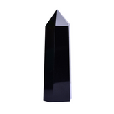 Polished black obsidian crystal point tower, single hexagonal pillar on white background, protection energy shield stone