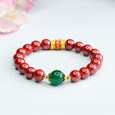 Cinnabar Agate Bracelet – Red beads with green jade accent on white, gold mantra bead