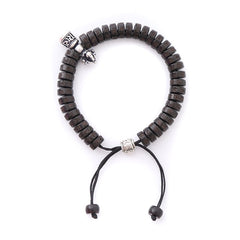 Coconut Shell Dorje Vajra Bracelet – Overhead view with carved beads, silver animal head charm, and sliding knot closure, ...
