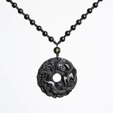 Black Obsidian Pixiu Pendant – Pendant on black beaded cord against clean white background
