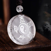Crystal Yin-Yang Bagua Pendant - etched trigrams on clear disc, Chinese Taoist spiritual necklace on dark wood
