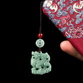 Jade Phone Charm – Celadon pixiu pendant with coin motif on embroidered red pouch, wealth protection charm