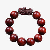 Red Sandalwood PiXiu Bracelet – Isolated red sandalwood bracelet with carved PiXiu on white, protection