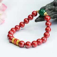 Cinnabar Agate Bracelet – Resting on dark stone prop with flowers, beaded bracelet