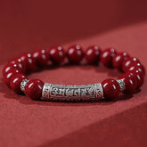 Cinnabar Sterling Silver Six True Words Bracelet – hero shot on red, silver mantra barrel & red beads, blessing bracelet