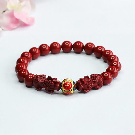 Cinnabar Double Pixiu Bracelet – red cinnabar beads with carved pixiu guardians and gold enamel fortune bead