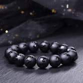 Black Onyx Mantra Bracelet – Matte black beads with carved Sanskrit characters on dark stone surface, black onyx bracelet
