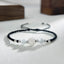 Sterling Silver Lotus Cat's Eye String Bracelet - black cord with silver lotus and white cat's eye beads, clarity