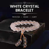 White Crystal Mantra Bracelet – Frosted beads with tassel on dark slate, meditation jewelry