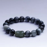 Eagle's Eye Jade PiXiu Bracelet – studio shot on white background, gray-blue beads with green PiXiu, clean