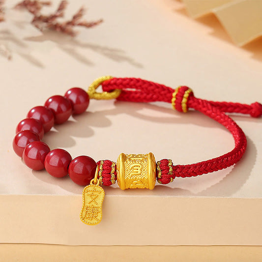Sterling Silver Cinnabar Bracelet – Red beaded bracelet with gold prayer wheel charm and braided cord, cinnabar jewelry