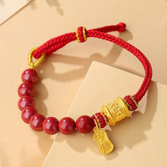 Sterling Silver Cinnabar Bracelet – Close-up of red cinnabar beads with engraved gold barrel charm, lucky red bracelet