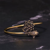 Lotus Koi Fish Copper Brass Luck Bangle – open cuff with sculpted lotus and koi with red eye, 45 angle on dark stone