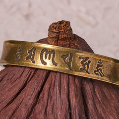 Om Mani Padme Hum Copper Cuff Bangle – Resting on natural gourd, texture contrast detail