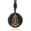Black Obsidian Mantra Pendant – polished black disc with gold Buddha and lotus engraving, black woven cord, protective talisman