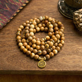 Mala Picture Jasper Lotus Bracelet - coiled on wood with fabric, grounding courage