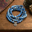 108 Mala Blue Aventurine Lotus Calm Bracelet – three-strand blue aventurine coils with silver lotus on wood, Focus
