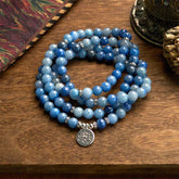 108 Mala Blue Aventurine Lotus Calm Bracelet – three-strand blue aventurine coils with silver lotus on wood, Focus