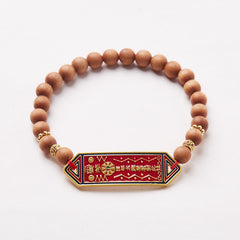 Sandalwood Bead Bagua Yin Yang Bracelet - overhead white studio shot showing gold spacer beads and red pendant, healing be...