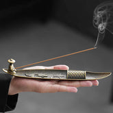 Koi Fish Boat Incense Burner - bronze boat with fisherman figure and incense smoke, held in hand, metalwork