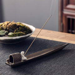 Fisherman Zen Ceramic Incense Burner – Diagonal view of brown boat holder with white figurine, aromatherapy accessory