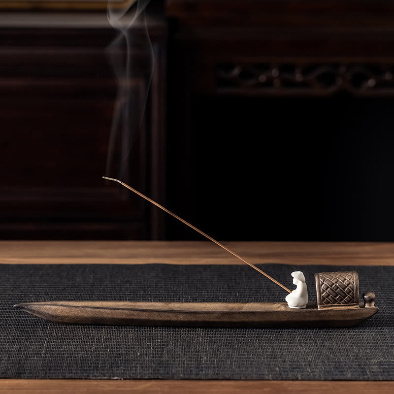 Fisherman Zen Ceramic Incense Burner – Boat-shaped brown holder with seated figurine and rising smoke, zen decor