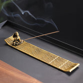 Bamboo Fishing Boat Alloy Incense Burner – golden raft with fisherman and rising smoke, tranquil zen ritual