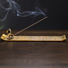 Bamboo Fishing Boat Alloy Incense Burner – side view brass raft with swirling smoke on dark wood, peaceful ambiance