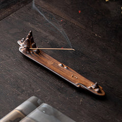 Mountains Boat Ceramic Incense Burner – top-down view of brown ceramic mountain burner with smoking incense on rustic wood
