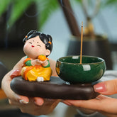 Tang Dynasty Lady Ceramic Incense Burner – Chubby lady in yellow dress holding orange beside green bowl, hand-presented warmth