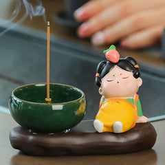Tang Dynasty Lady Ceramic Incense Burner – Strawberry lady napping beside green bowl, incense smoke rising
