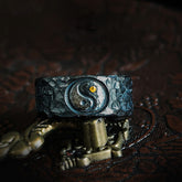 999 Sterling Silver Yin Yang Ring - frontal view on dark stand showing oxidized hammered band with gold yin-yang accent, m...