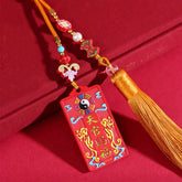 Natural Cinnabar Bagua Yin Yang Fu Hanging - three-quarter view on red fabric showing bagua pendant with beaded tassel, fe...