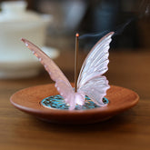 Butterfly Liuli Glass Incense Burner - Pink translucent butterfly on carved wood dish with glowing ember, healing decor