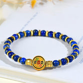 Lapis Lazuli Bracelet – blue beads with gold spacers and mantra medallion on open book with botanicals, balance