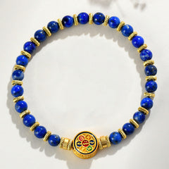 Lapis Lazuli Bracelet – top down circular arrangement on white with gold spacers and enamel medallion, balance
