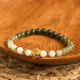 Hetian Jade Gradient Lotus Bracelet – ombre green-white beads on wooden dish with gold lotus, Balanced