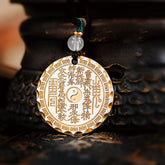 Mountain Ghosts Spend Money Yin Yang Bagua De - Taoist amulet on dark display stand, gold yin-yang talisman, protective neckl