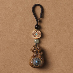 Sandalwood Om Mani Padme Hum Key Chain – light wood pendant with dark cord, peaceful mindful
