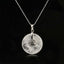 Tree of Life Crystal Necklace – clear quartz donut pendant on black background, frontal silver chain view