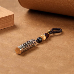 Tibetan Copper Vajra Key Chain – warm bronze patina cylinder with Bodhi seed bead three quarter view, strength