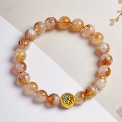 999 Sterling Silver Citrine Om Mani Padme Hum Bracelet – three-quarter view on dual-tone background with traditional Asian art, visible red cord and Sanskrit mantra bead