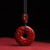 Cinnabar Lotus Peace Buckle Necklace - single red bi-disc pendant with cloud carvings on black cord, Bold