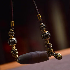 Tibetan Dzi Bead Agate Protection Pendant – hanging close-up, carved metal beads and barrel agate focal, spiritual pendant...