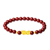 999 Gold Cinnabar PiXiu bracelet – red cinnabar beads with gold PiXiu on white background, clean view
